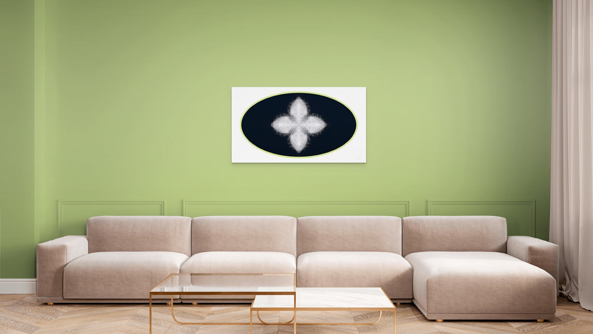 Beige sectional sofa in a living room with a green wall and geometric white, black and green artwork on wall.