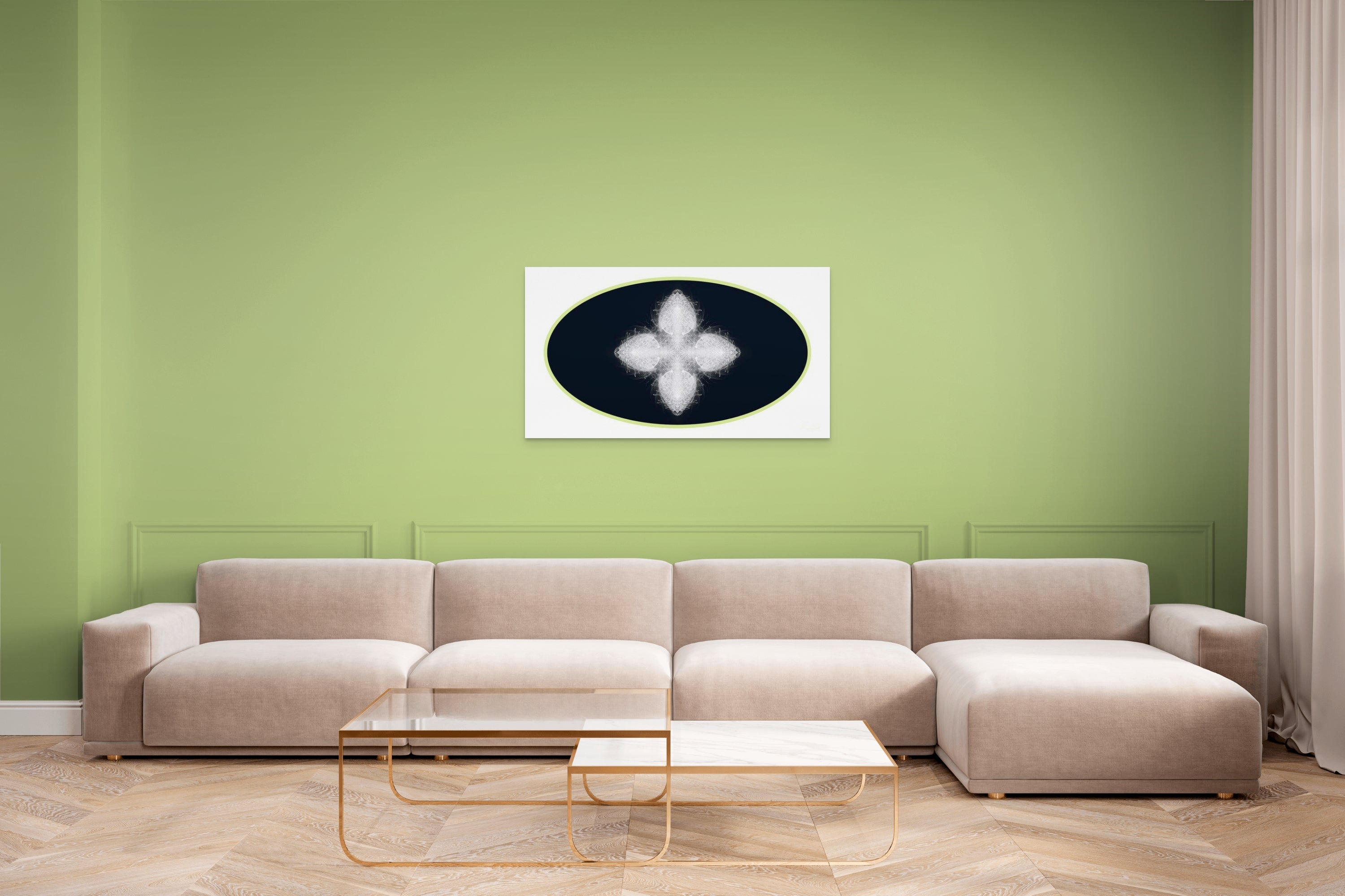 Beige sectional sofa in a living room with a green wall and geometric white, black and green artwork on wall.
