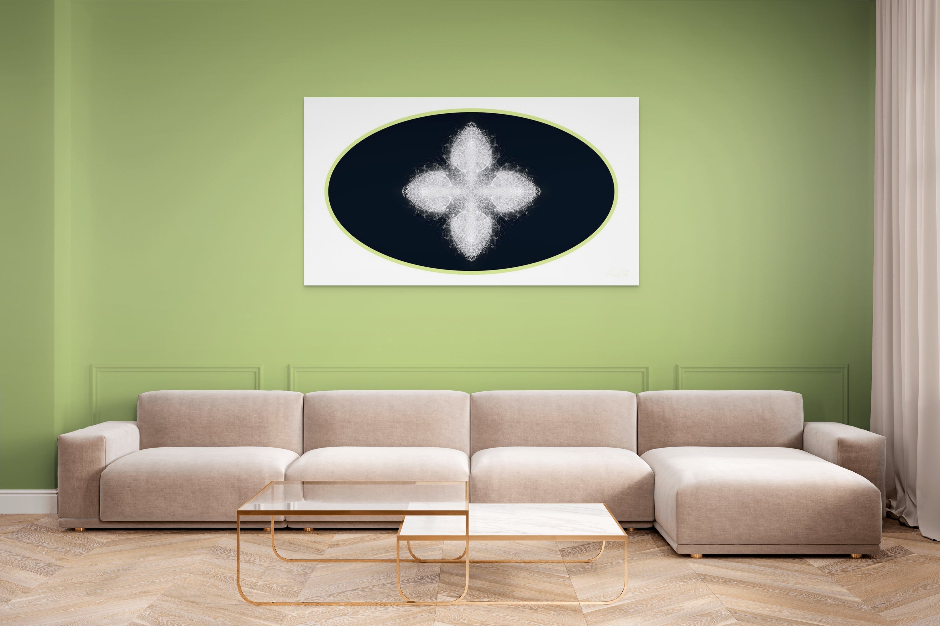 Beige sectional sofa in a living room with a green wall and geometric white, black and green artwork on wall.