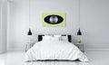Modern bedroom with white bedding, a black bed frame, and a white, black and green artwork on the wall.