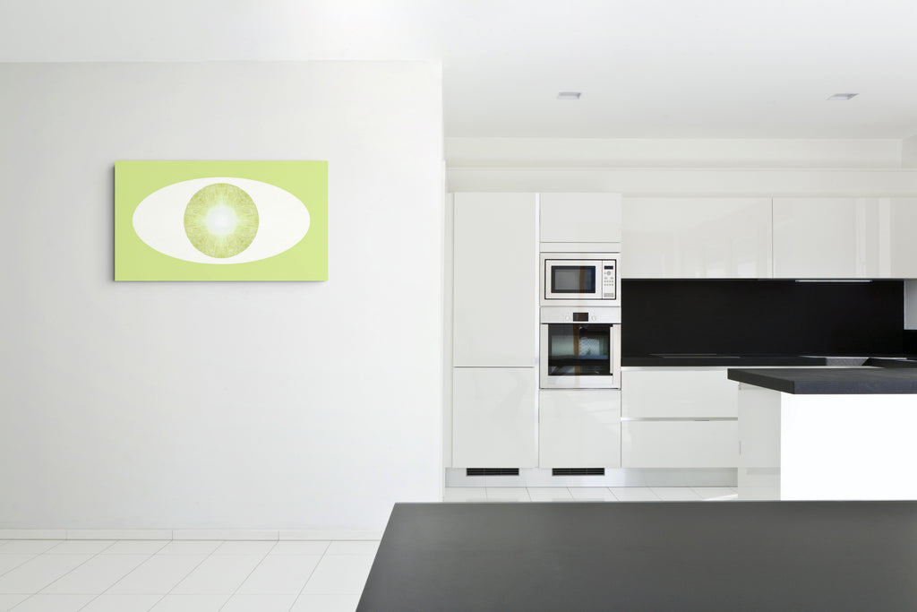 Modern kitchen with white cabinets, black  countertop and backsplash, and a green and white abstract artwork on the wall.